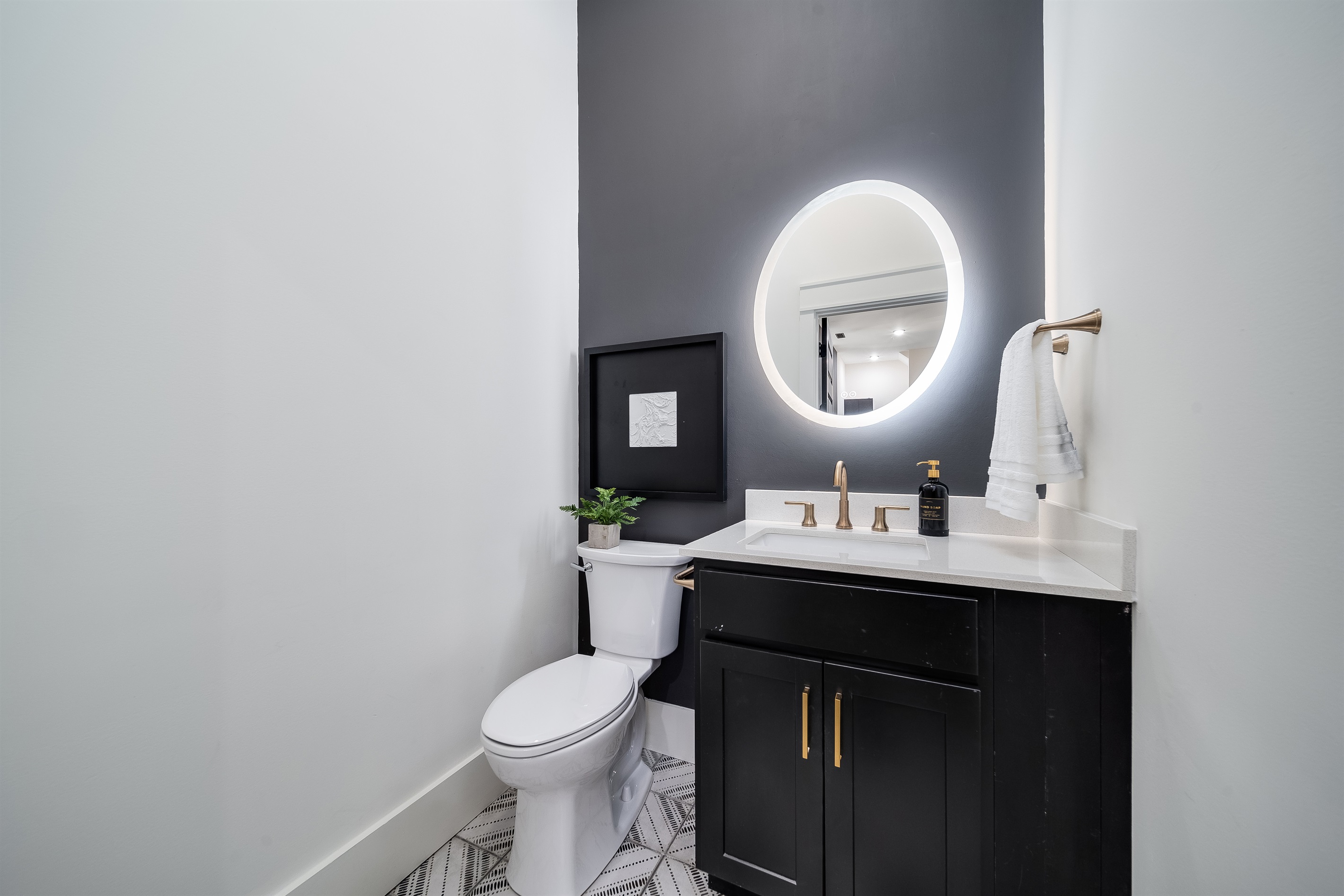 Includes a charming half-bath with a modern vanity, providing that essential extra space!