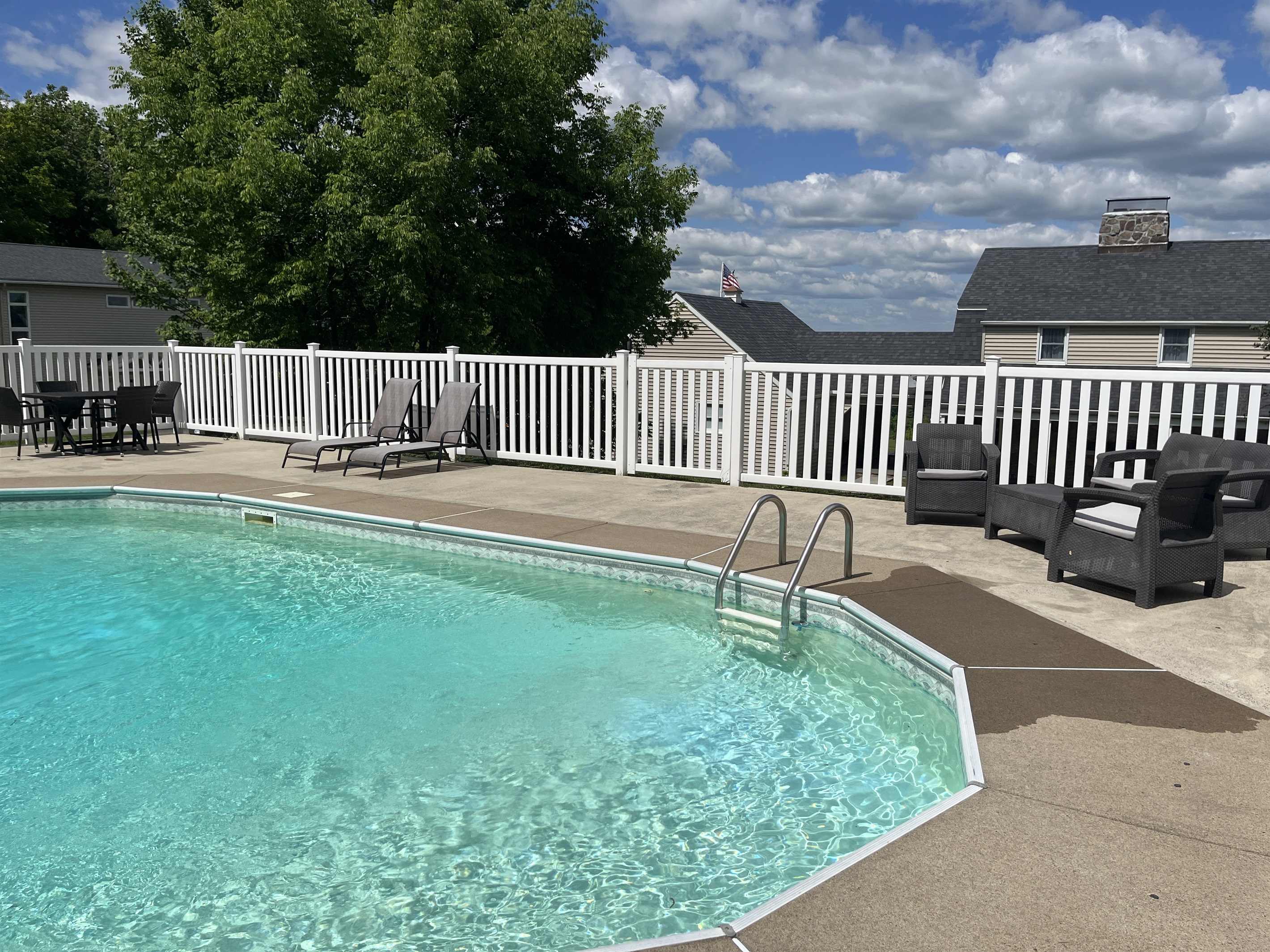 Hilltop Hideaway in-ground pool with lounge furniture.
