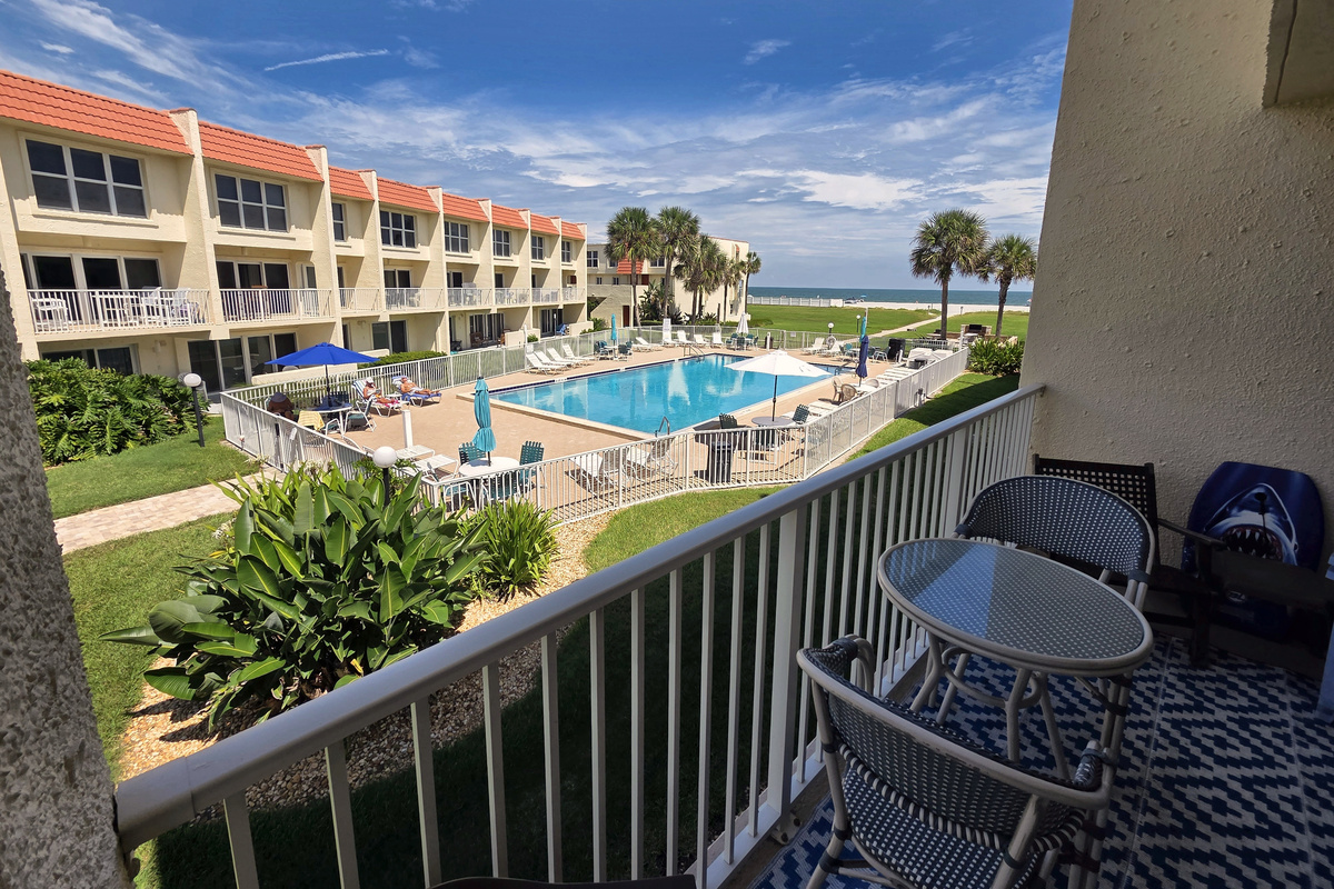Private balcony overlooking the pool and ocean, perfect for morning coffee.