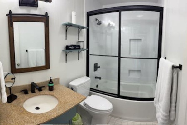 Refresh in the bathroom, complete with a sink, shower, and all the essential amenities for a comfortable and convenient stay