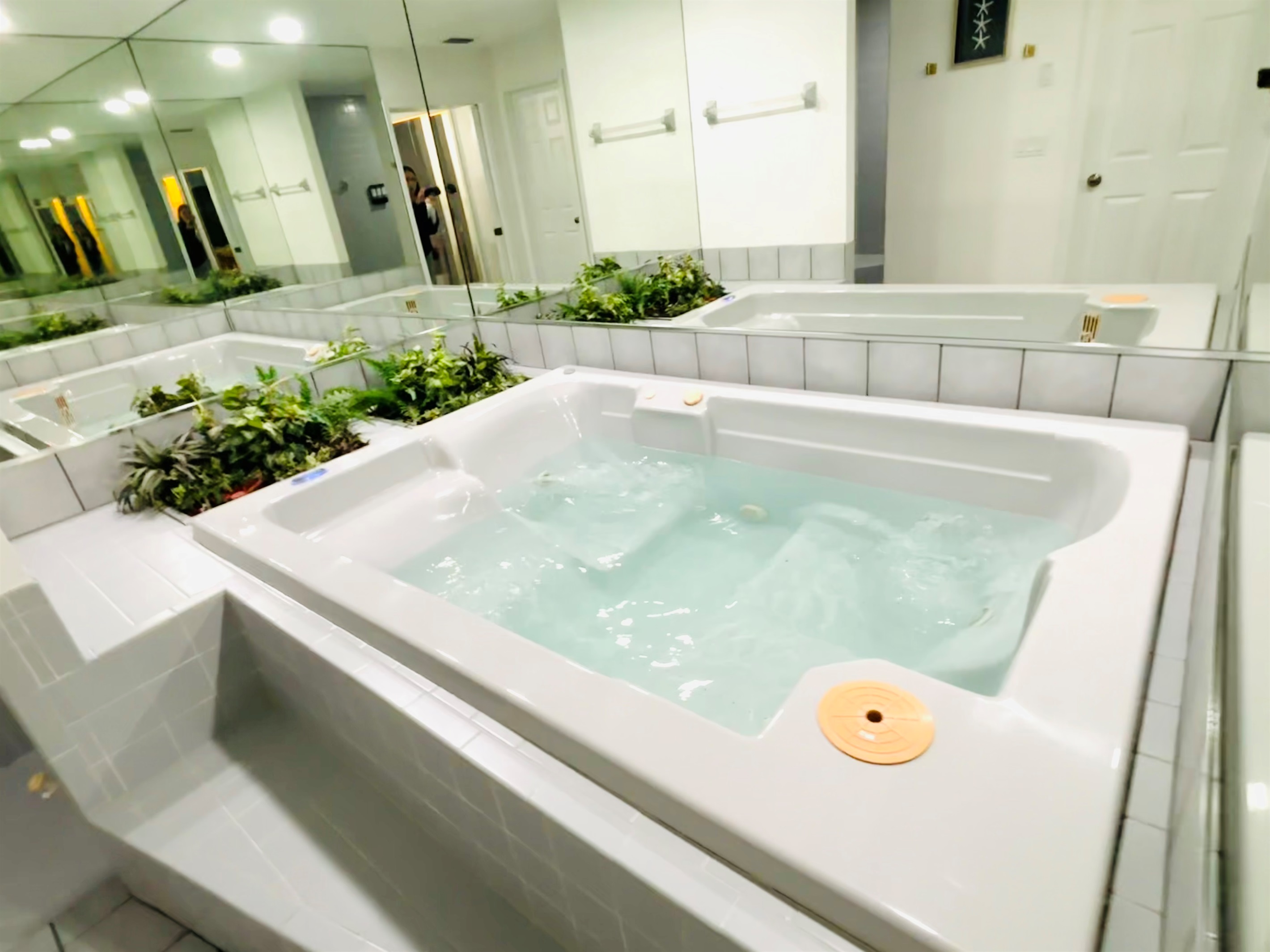 Large jacuzzi hot tub (optional use) in bathroom in Coastal Retreat Primary Suite 