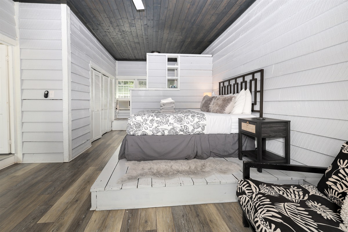 Bedroom 1 with Queen bed. *Note the bed is up on a platform