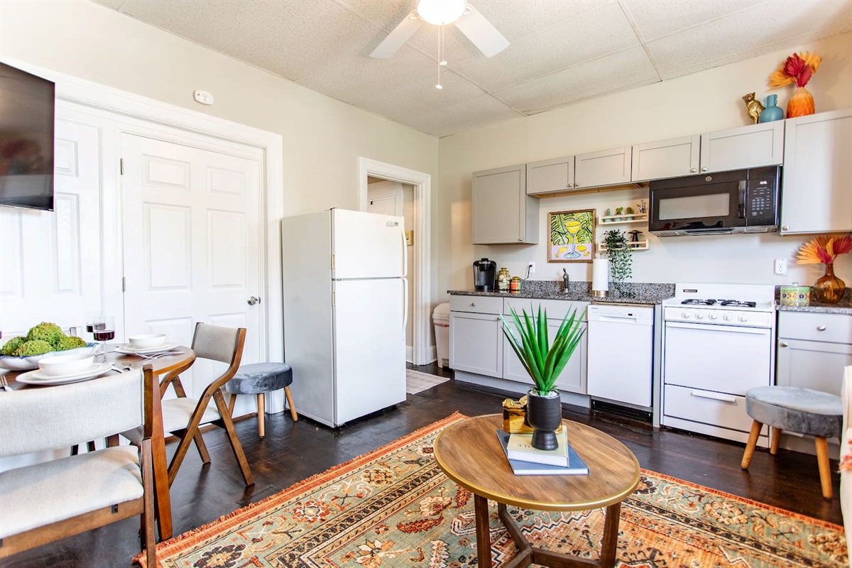 Open view of the kitchen from the living area couch, creating a seamless flow between spaces while allowing you to enjoy the heart of the home from your seat.