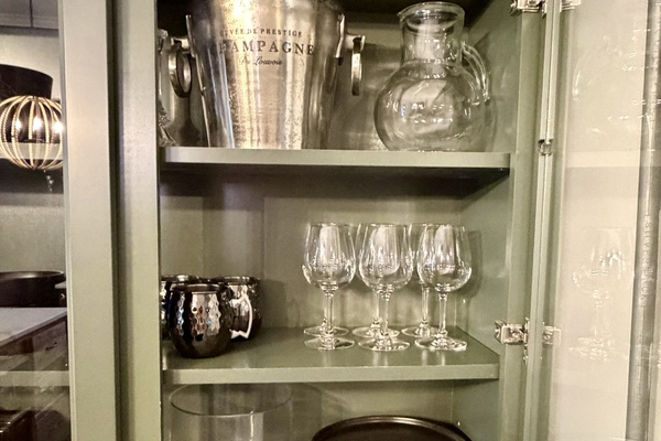 Full equipped kitchen with pots and pans, dishesm and stemware