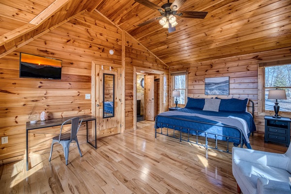 One of the 2 upstairs bedrooms, both with a king bed, private bathroom, and sleeping nook sitting in a huge window with stunning mountain views!