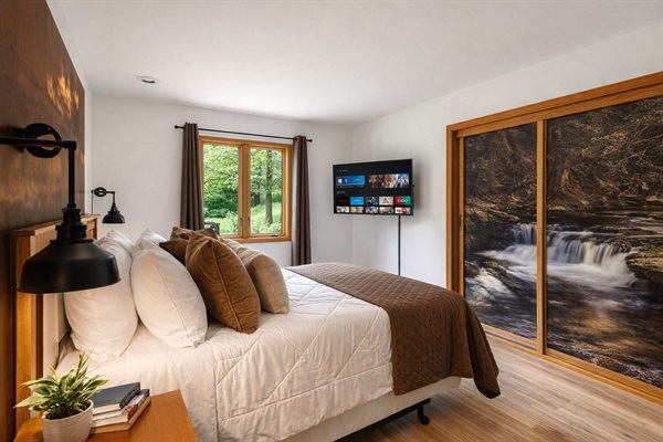 The Elk Room features a comfy queen bed, private streaming TV, and a one-of-a-kind wall mural of Wycoff Run Falls—a tribute to local beauty.