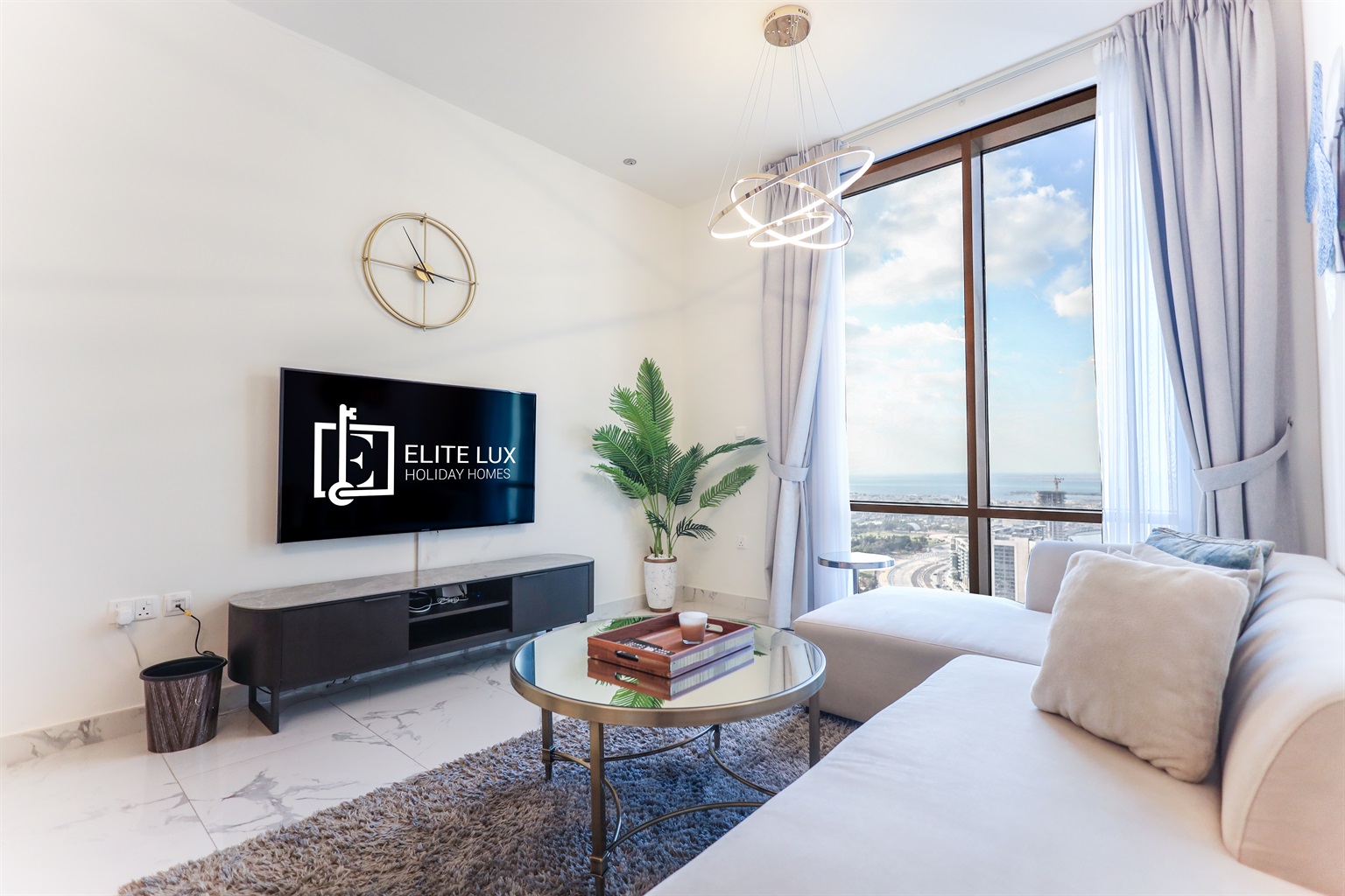 The living room equipped with a comfortable sofa, a coffee table and TV.