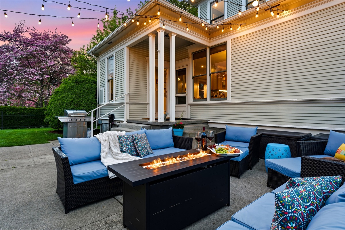 Back patio, surrounded by mature trees and historic charm and equipped with lounge seating and BBQ (propane provided)