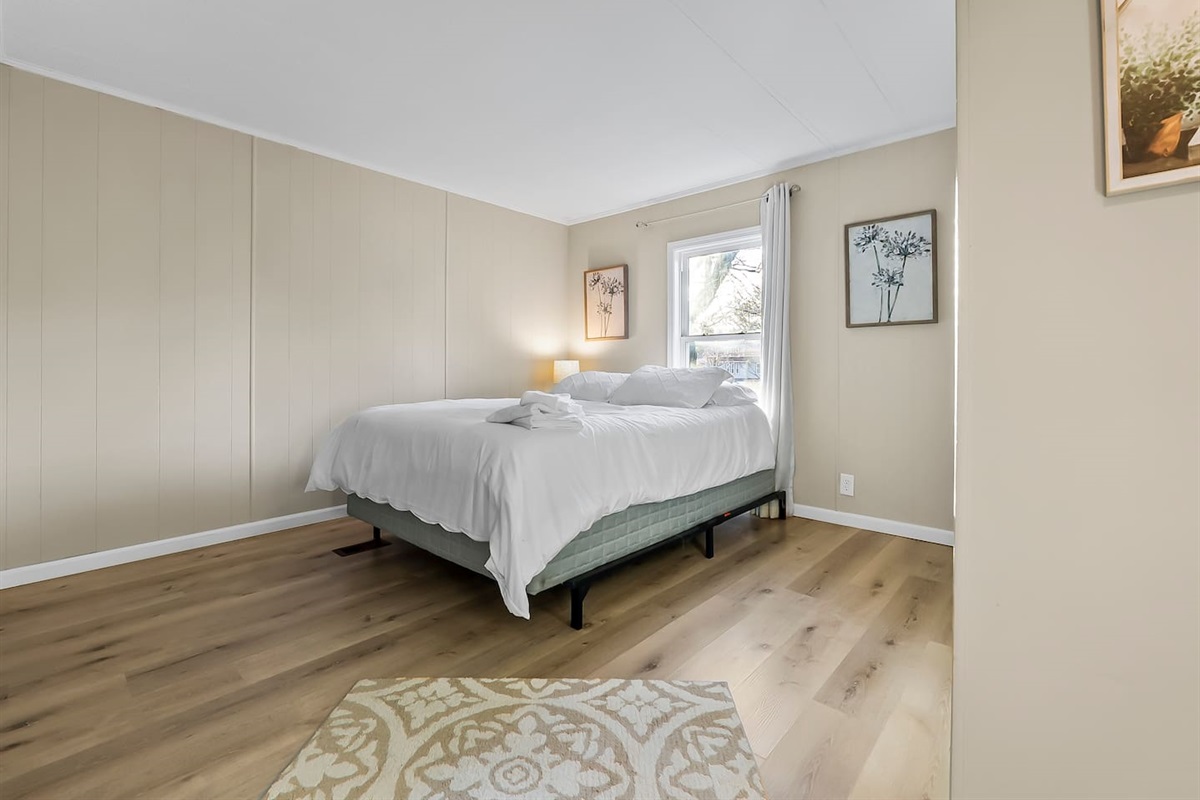 Spacious second bedroom with a large window letting in natural light for a relaxing stay.