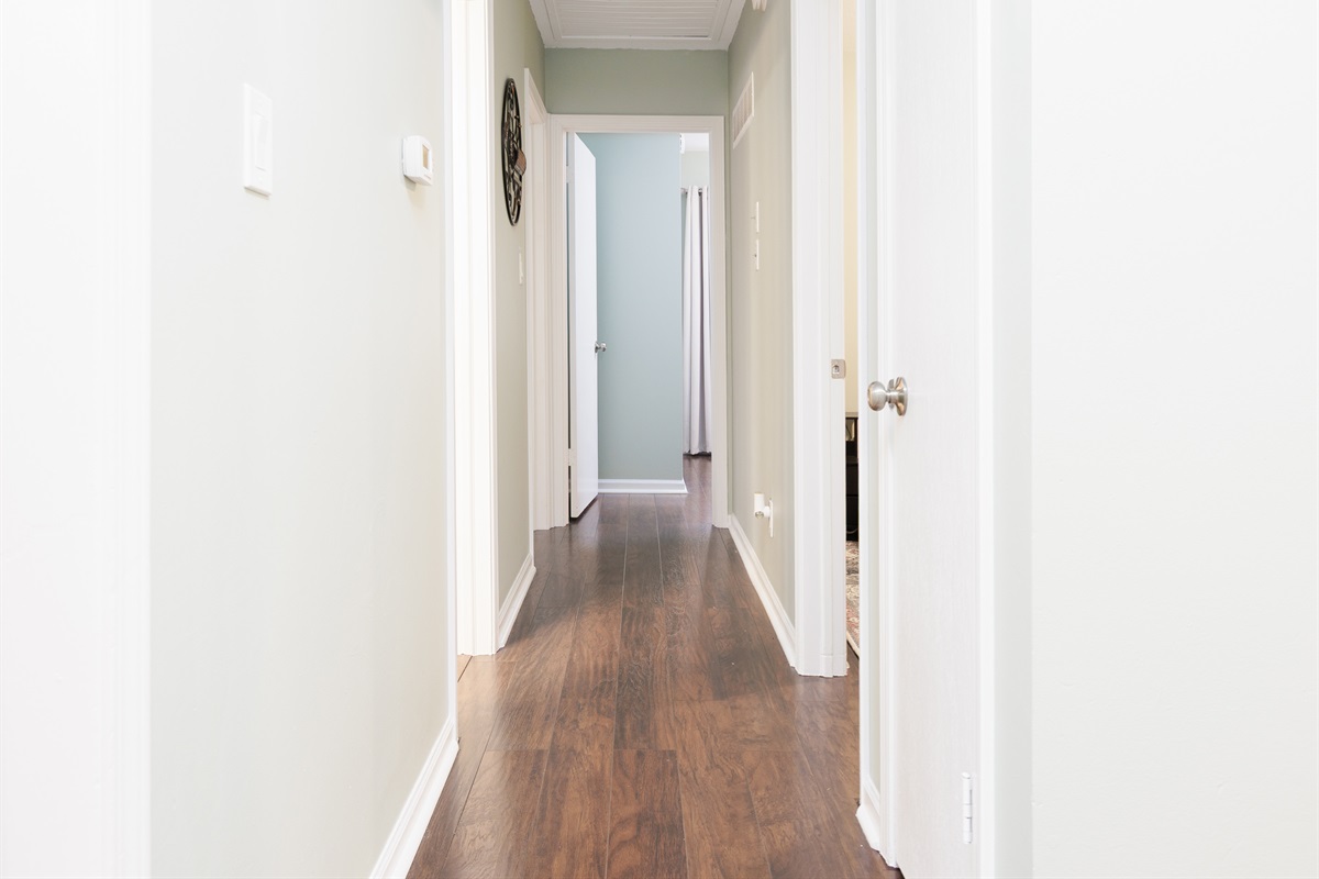 Clean, well-lit hallway connecting bedrooms and main living spaces for easy flow throughout the home.