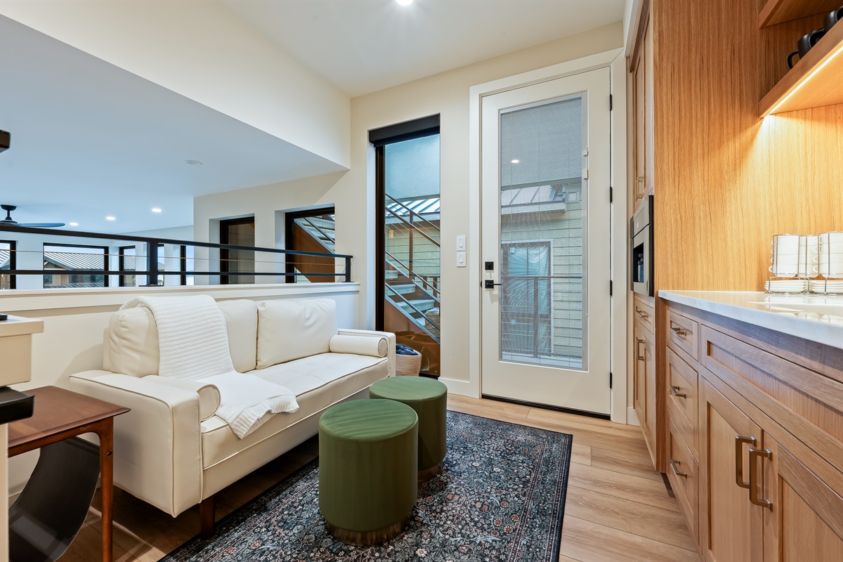 Upstairs lounge and coffee bar area with Miele espresso maker and mini fridge