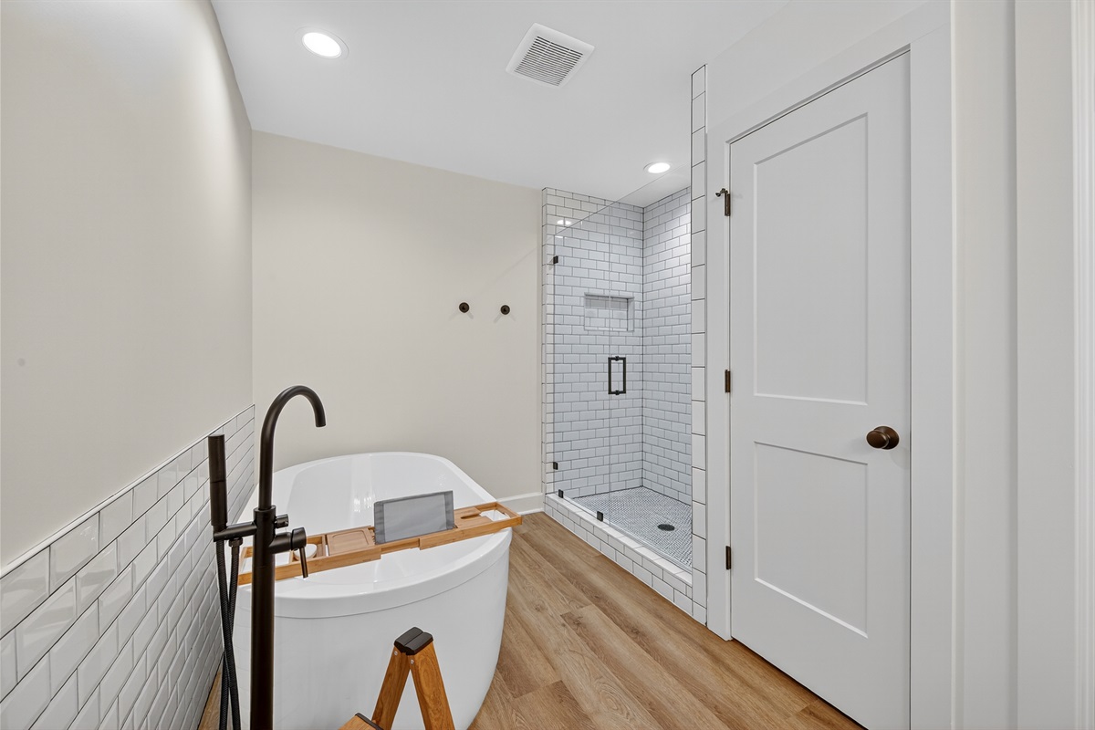 Spa-inspired bathroom with a freestanding soaking tub, walk-in shower, and timeless subway tile detailing for a truly relaxing experience.