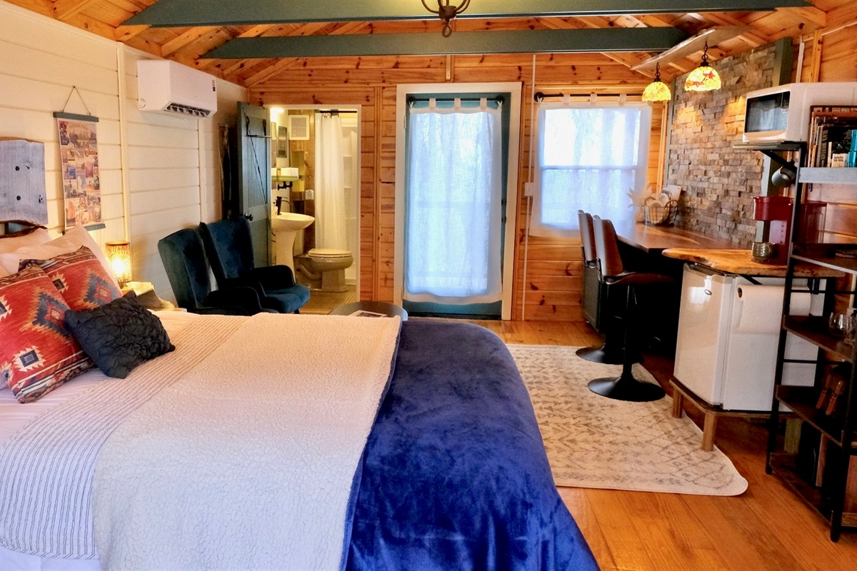 Everything you need in your Cabin, Queen Bed, Bathroom, Kitchenette, Seating and Dining Areas.