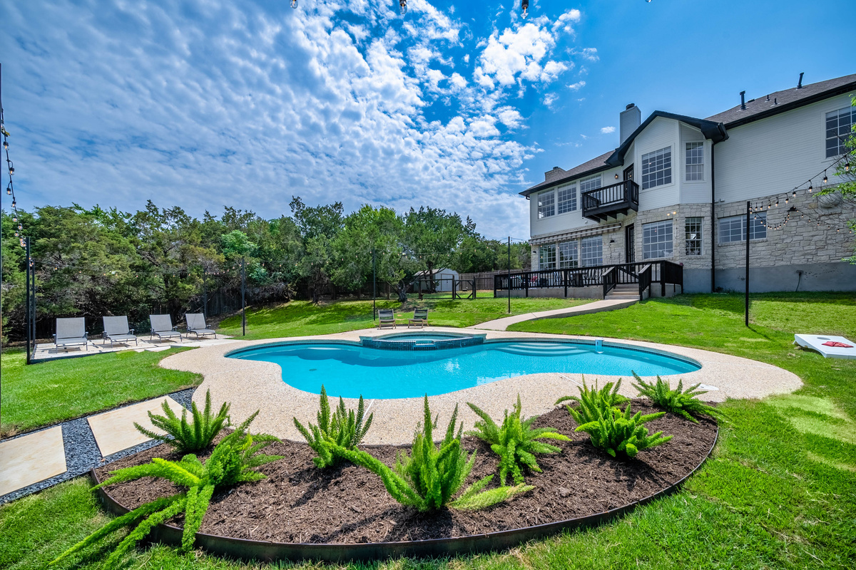 Freshly landscaped pool area offers a peaceful backyard escape.

