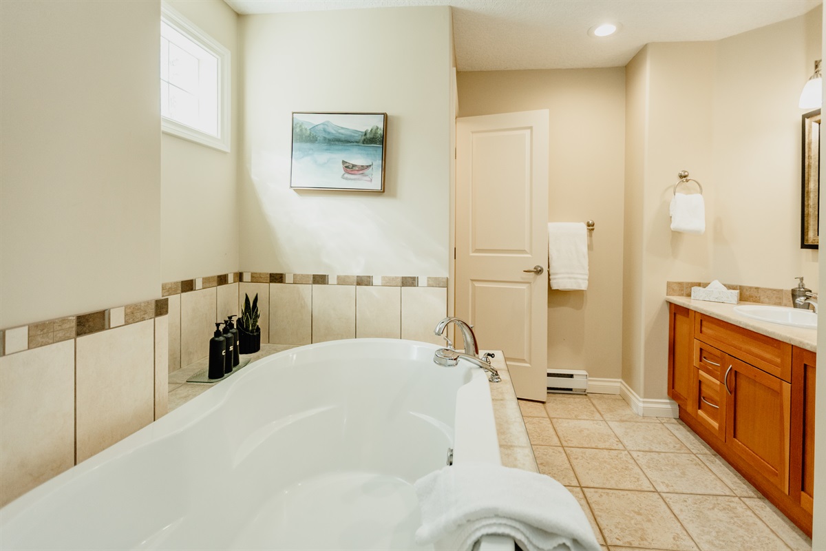 Unit A. Soaker tub and private toilet in Primary bedroom.
