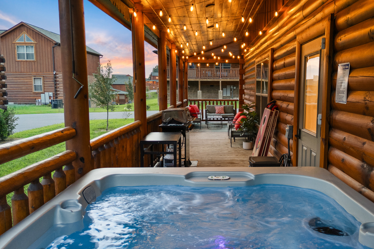 Relax in the hot tub located at the back of the cabin on the wrap around porch.