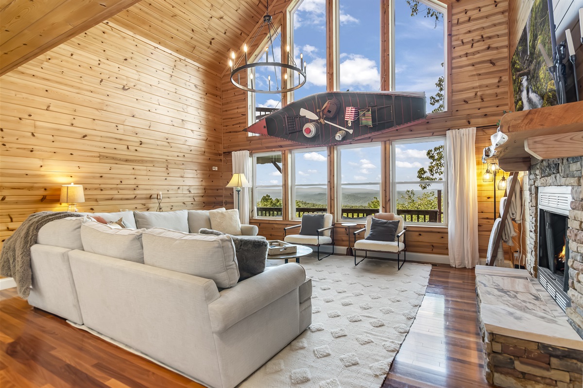 Living room w/ wall of windows and views of mens