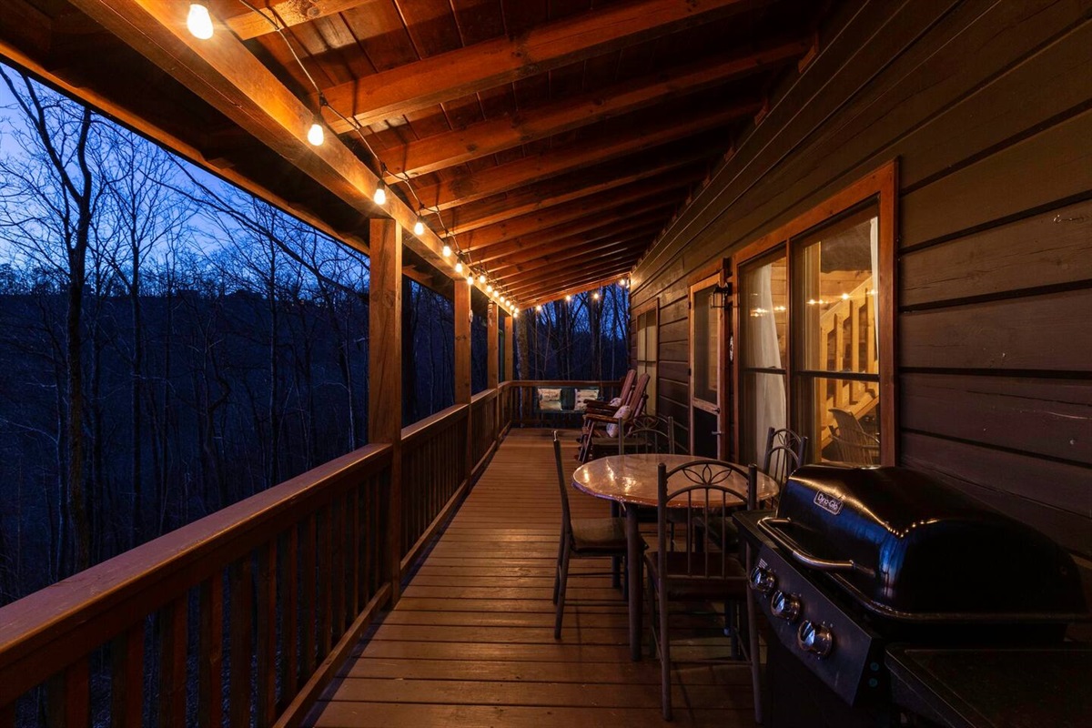 Grill and eating area on porch.