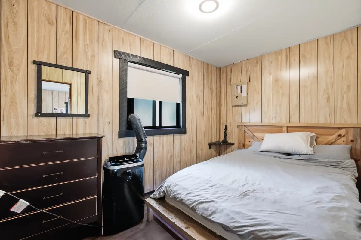 Comfortable bedroom with dresser and natural light