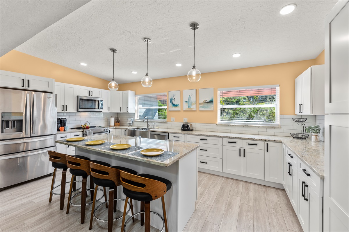 Large kitchen with island and stainless steel appliances