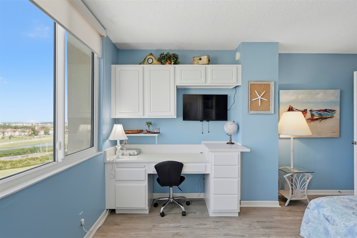 The second bedroom offers a relaxing space featuring a comfortable Murphy bed, stunning bay views, and plenty of closet storage. It also includes a dedicated workstation, making it ideal for working professionals or guests needing a quiet space.