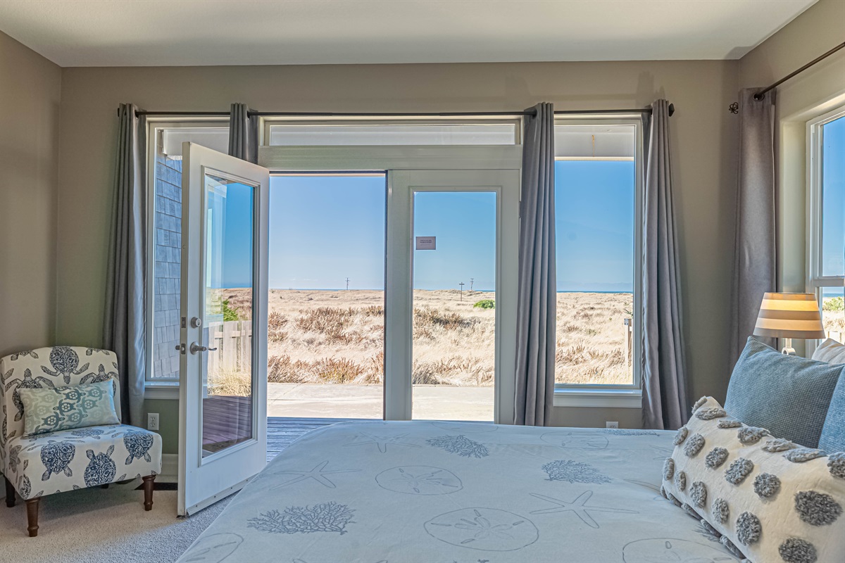 Primary bedroom on main floor has French doors leading out to private deck and gorgeous ocean views!!