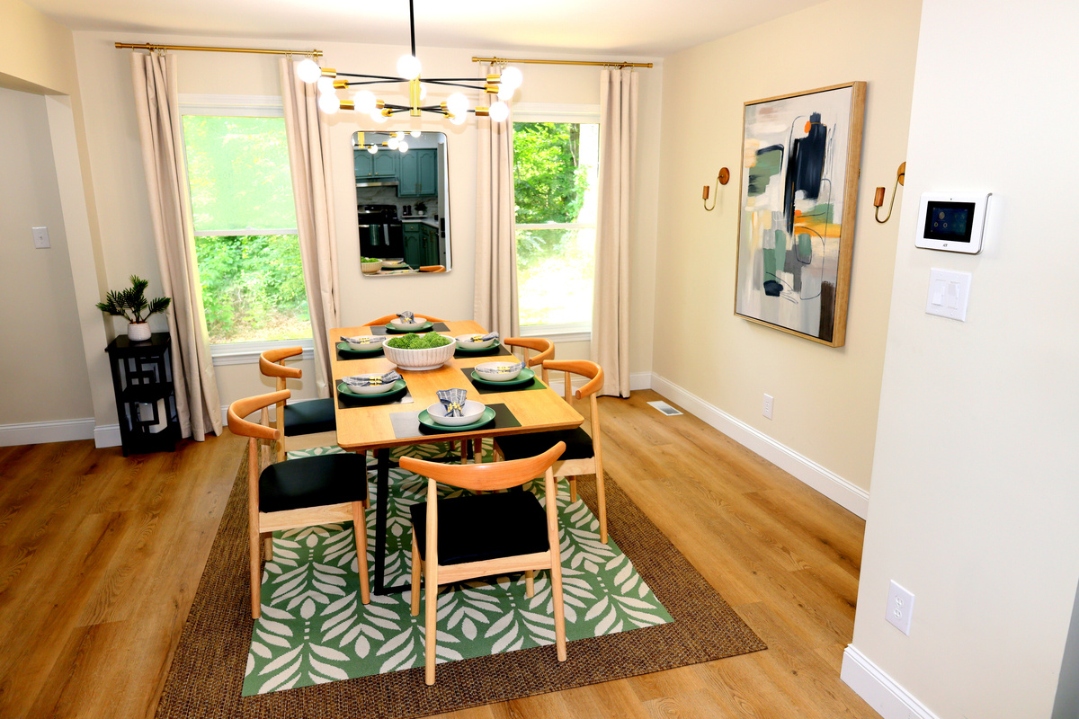 Bright dining area with seating for group meals, modern lighting, and stylish table settings