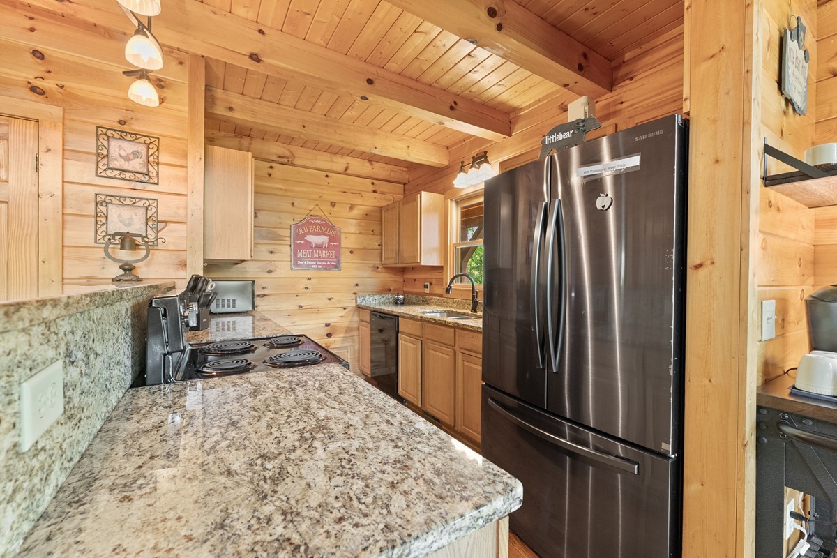Fully equipped kitchen with modern conveniences and cabin charm.