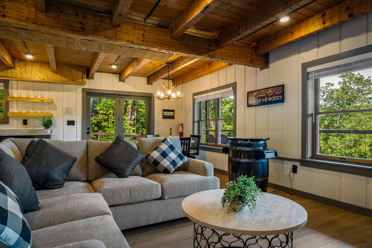 Comfortable lower-level family room with arcade video game, poker table, wet-bar, and smart TV