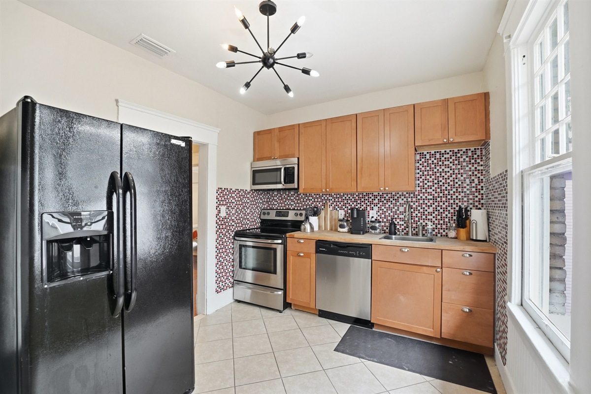 Full kitchen with refrigerator, dish washer, stove and microwave