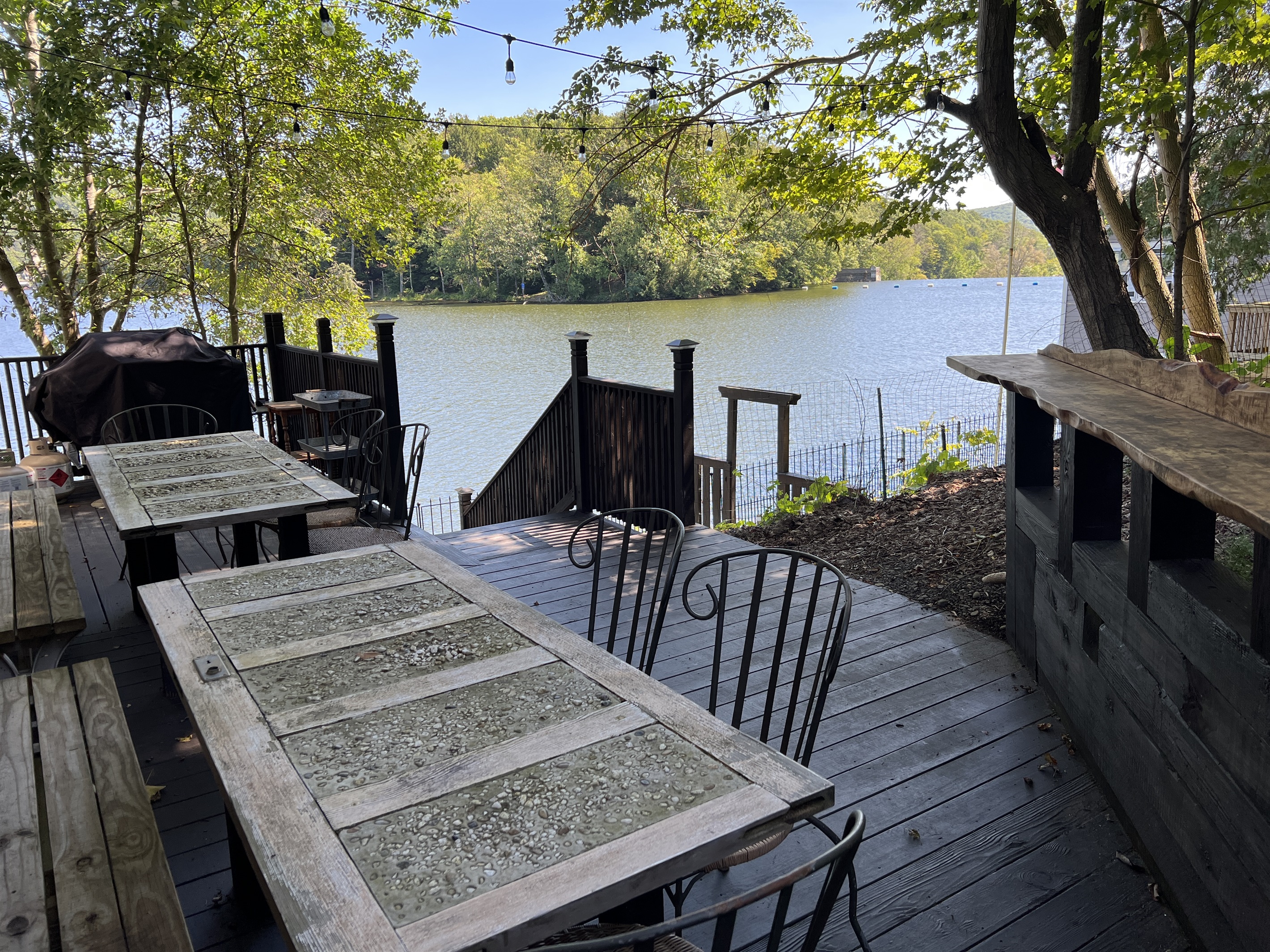 Outdoor seating and dining at the main house, overlooking the water.