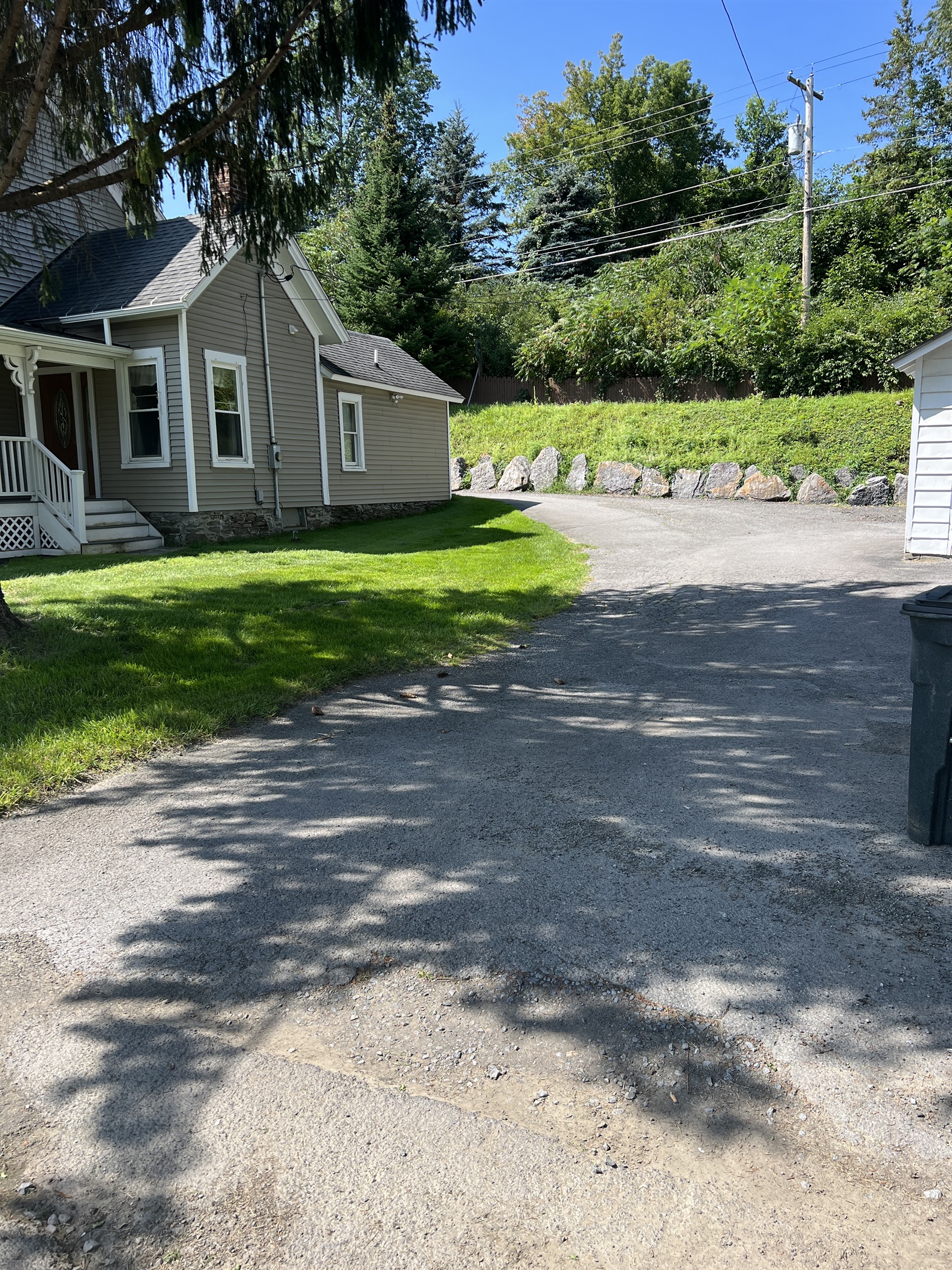 Driveway access wraps around house to other side
