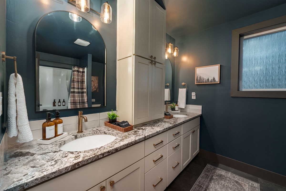 Beautiful hall bathroom serving Bedrooms 2 & 3, with dual sinks, ample counter space, and a full tub-shower combo for easy family use.