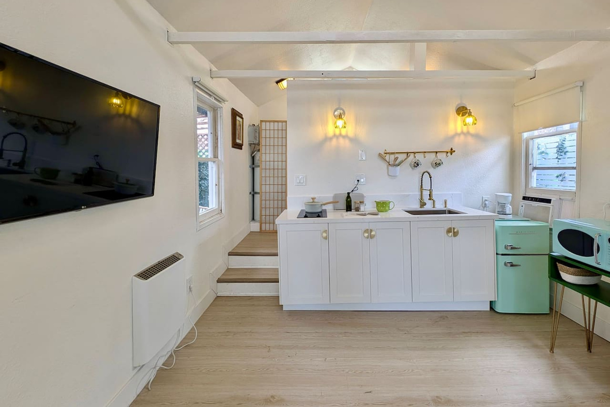Open-concept studio with kitchenette and Smart TV.