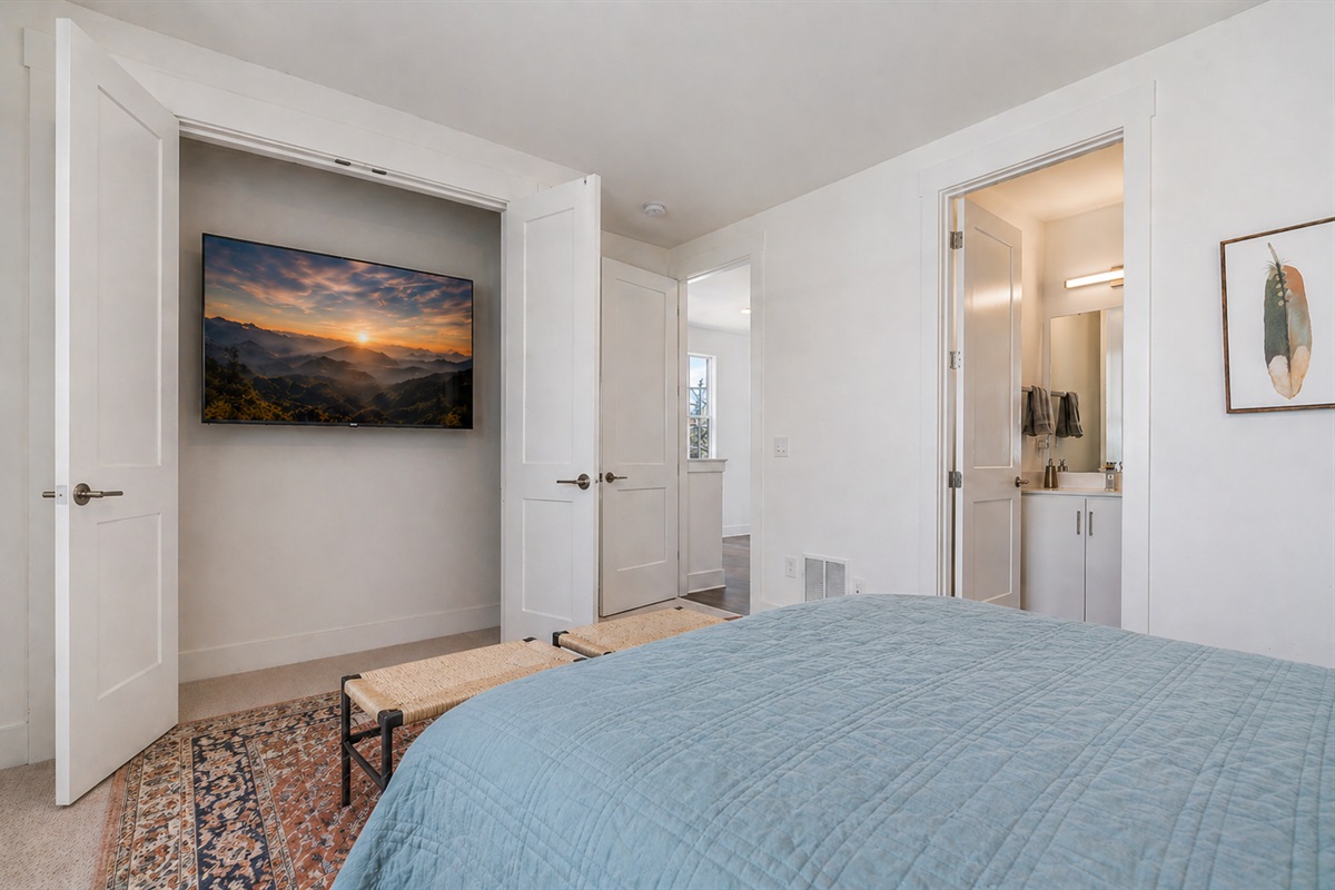 The spacious 2nd king bedroom (located on the 3rd floor) has a surprise 65" TV tucked inside the closet! 