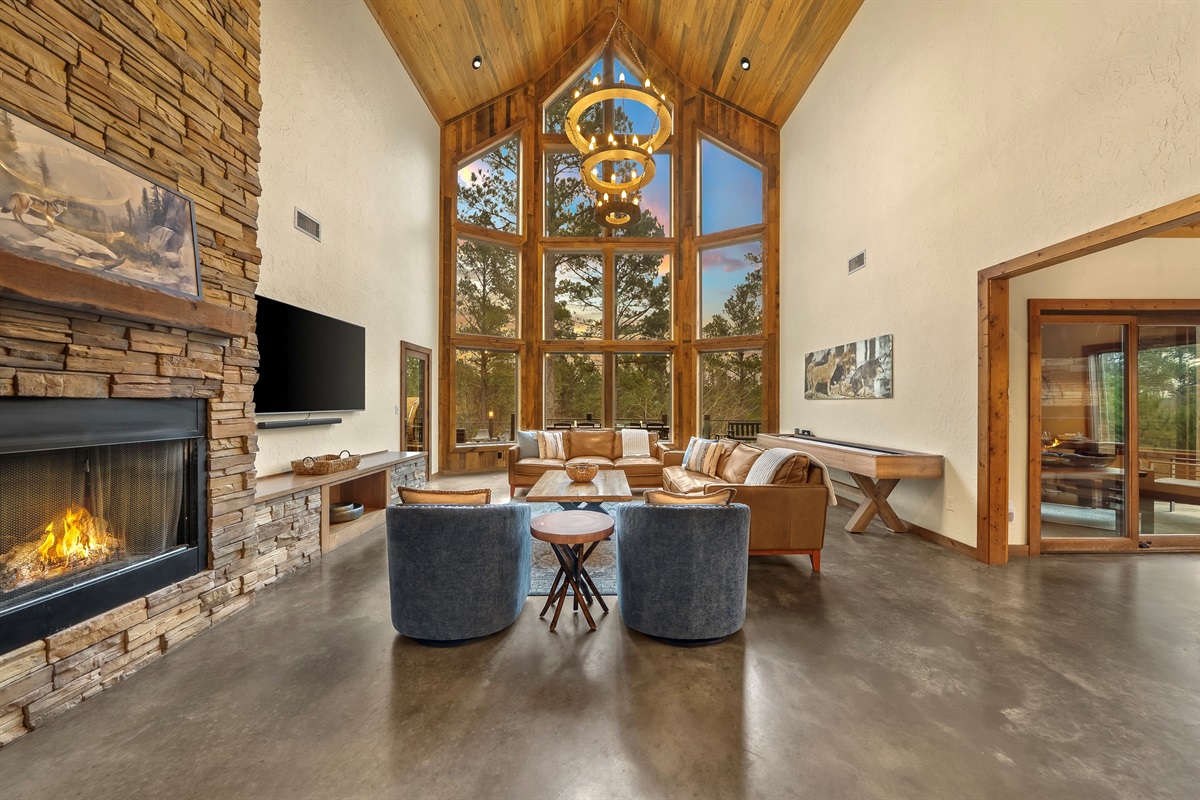 A bright, open great room with soaring windows and plenty of space for everyone to gather.