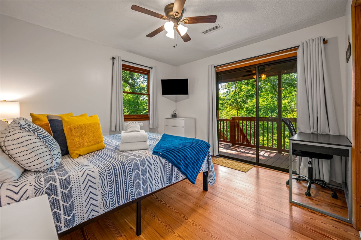 Walk out through a sliding glass door to the upper covered porch. This room also has a desk and chair for the family workaholic. Smart TV included. Ceiling fan, blackbout curtains, and a memory foam mattress will have you sleeping soundly. 