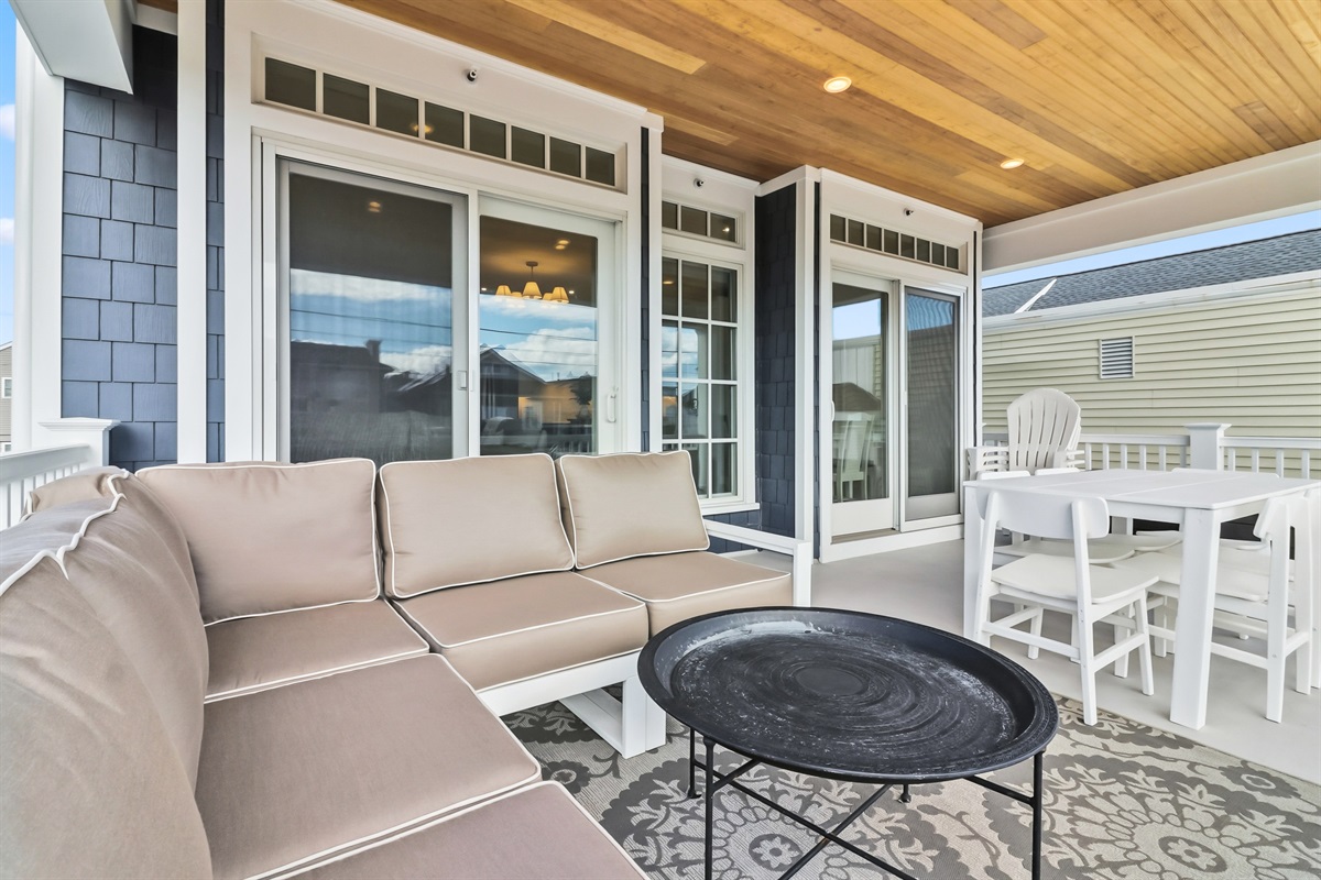 Covered balcony area with outdoor seating