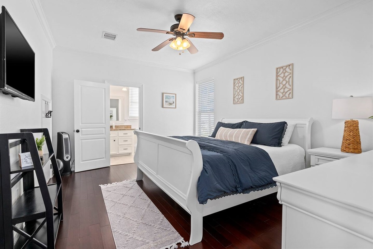 Primary bedroom with king sized bed and private en-suite bathroom.
