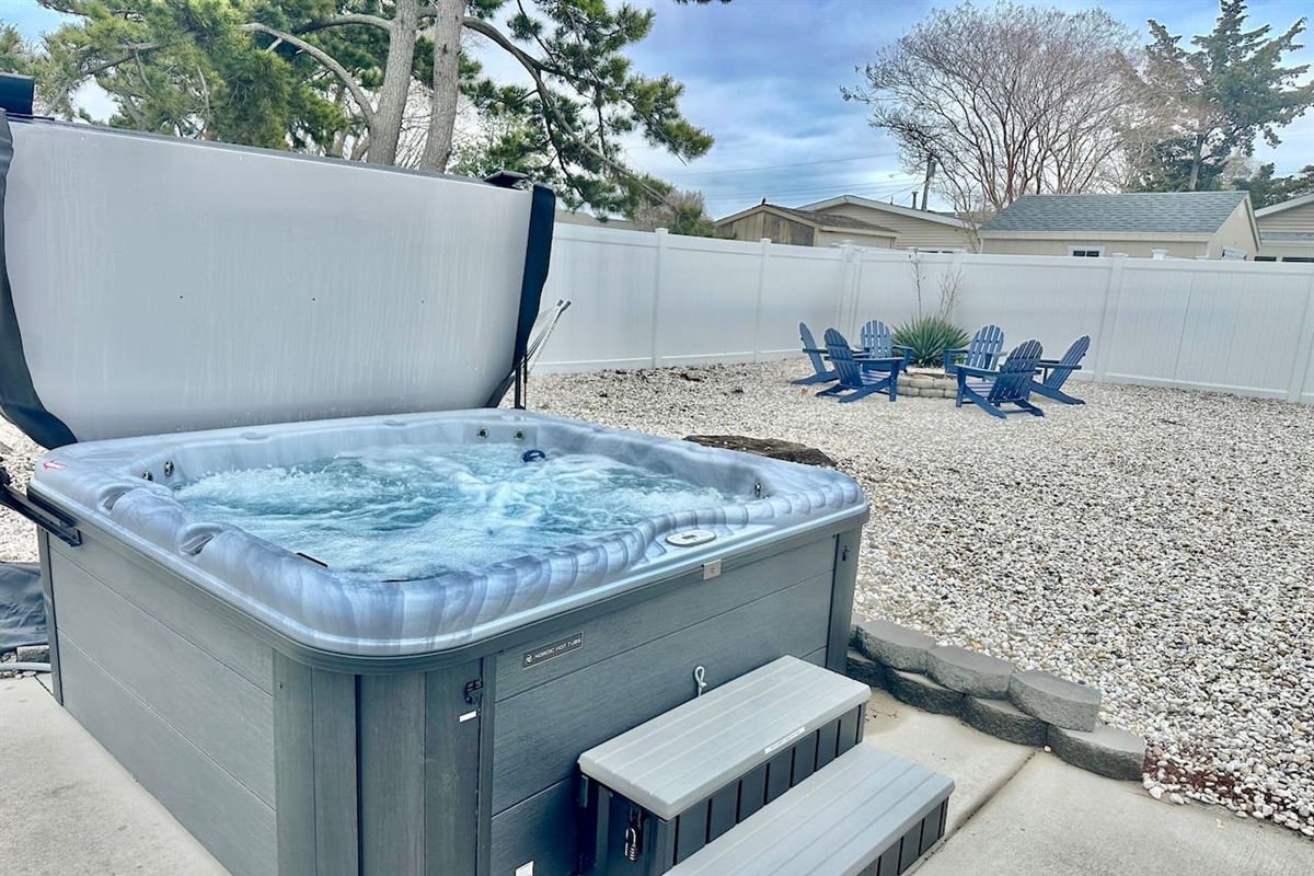 Unwind in our private hot tub, perfectly situated for stargazing. The fenced backyard also features a gravel lounge area with Adirondack chairs—the ultimate spot for evening relaxation and fresh air.