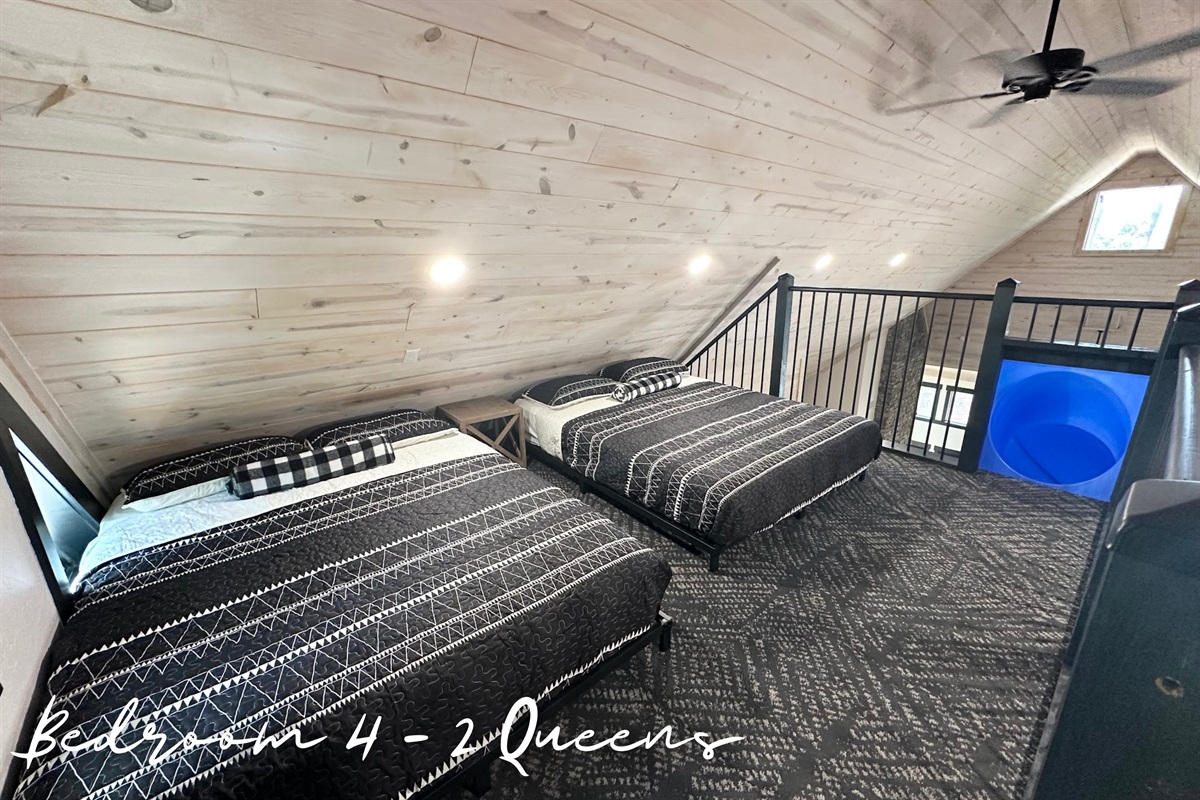 Open loft vibes, 2 queen beds with soaring ceilings, huge windows, and your own epic slide drop into the main living space. Talk about a grand entrance!
