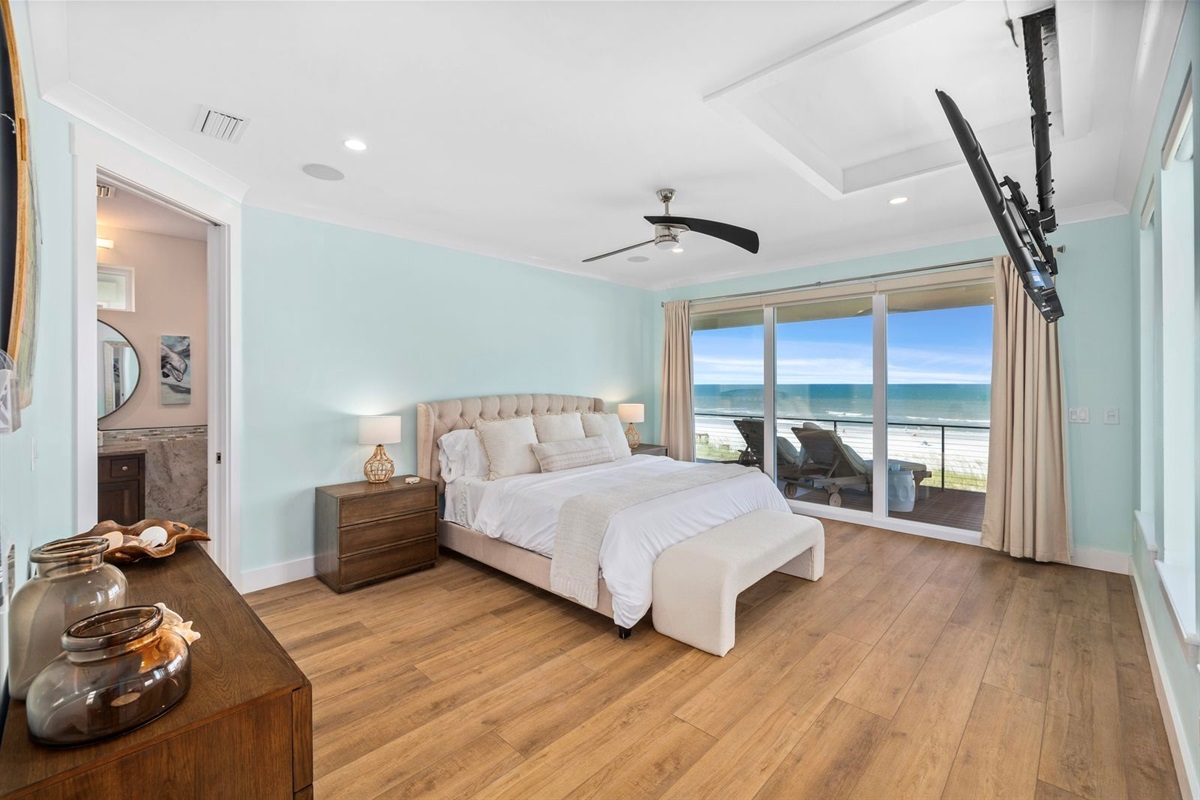 Primary suite with king bed, vaulted ceilings, and sweeping ocean views