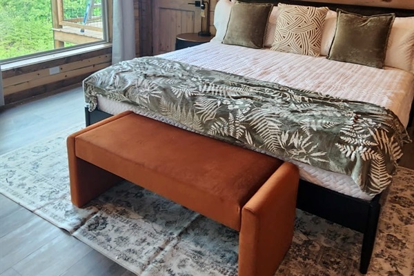 Bedroom with king bed, wood paneling, and cozy decor