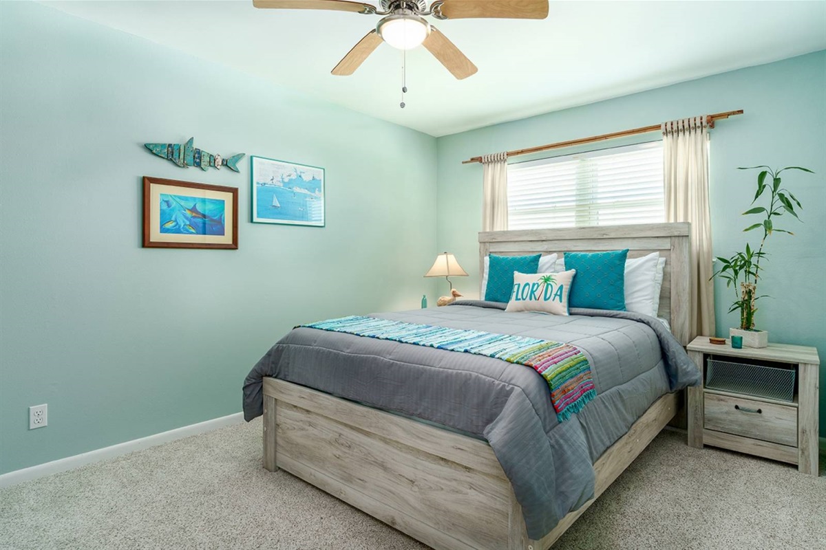 The guest room is full of character. Nautical art, ocean blues, and a queen bed. The Perch comfortably sleeps 6 guests across three sleeping areas.