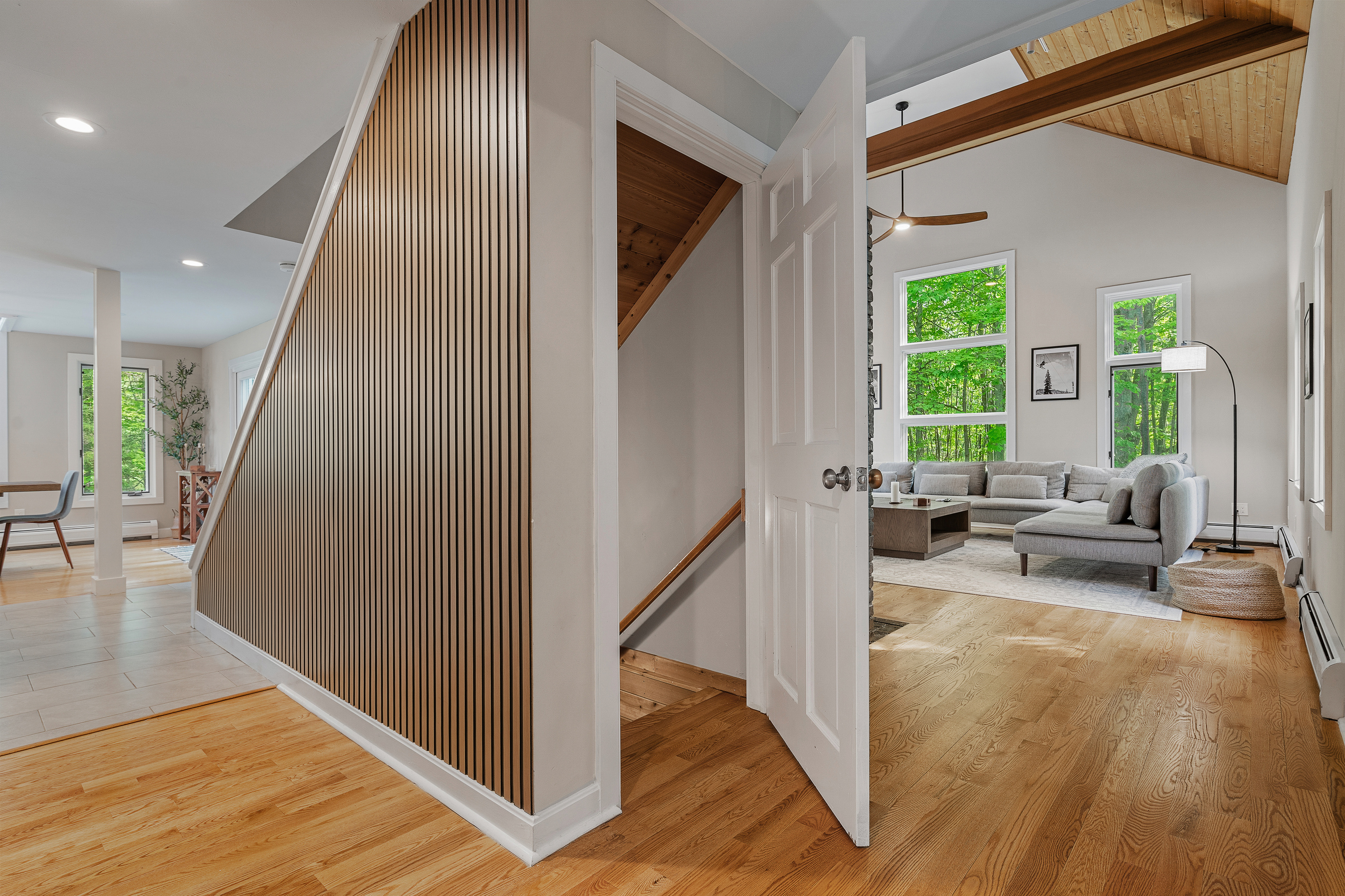 Entry hall with slat-wood accent wall opening to the living room at First Chair Lair