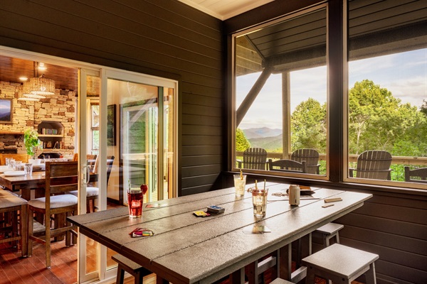 Screened-In Dining Porch with Mountain Views—Perfect for Meals, Games and Relaxing Outdoors.