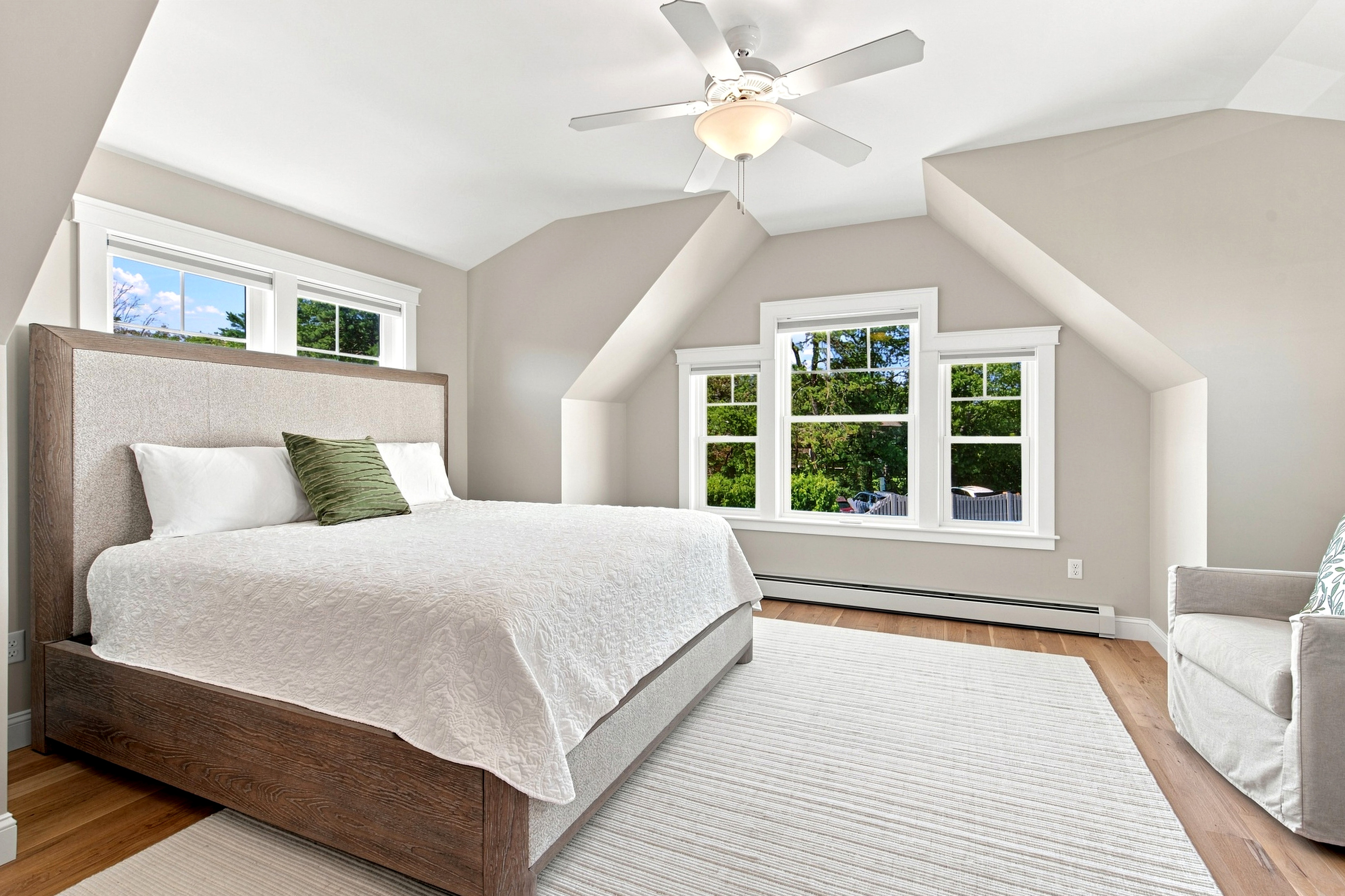 Wake up to abundant natural light in this serene bedroom designed for restful nights and easy vacation mornings.