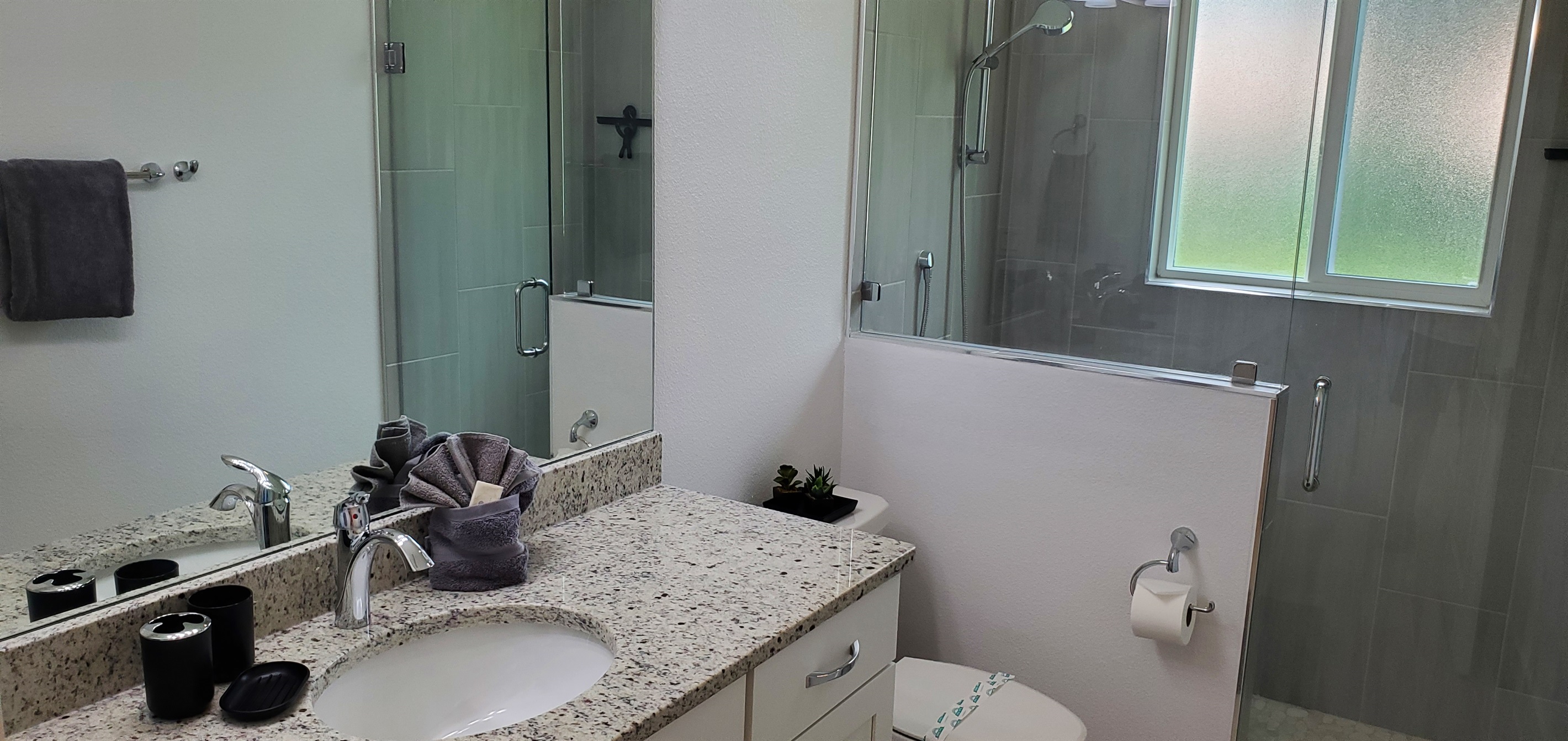 Shared full bathroom with walk-in shower