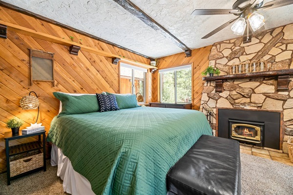 Our second bedroom is located downstairs and features a king size bed and wood-burning fireplace