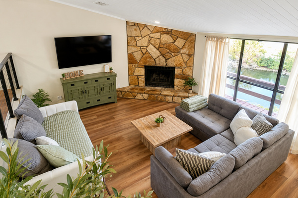 Open living room with fireplace and panoramic lake views.